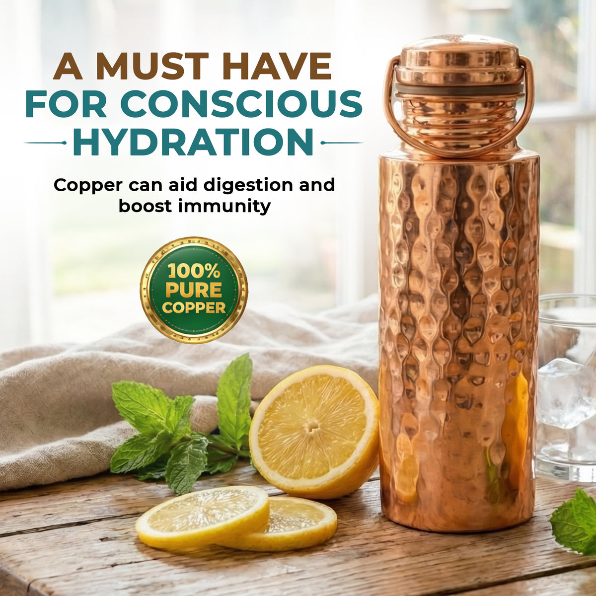 A hammered copper water bottle with a metal handle, displayed on a rustic wooden table with lemons, mint, and a glass of water. Text overlays read 'A MUST HAVE FOR CONSCIOUS HYDRATION' and '100% PURE COPPER'.