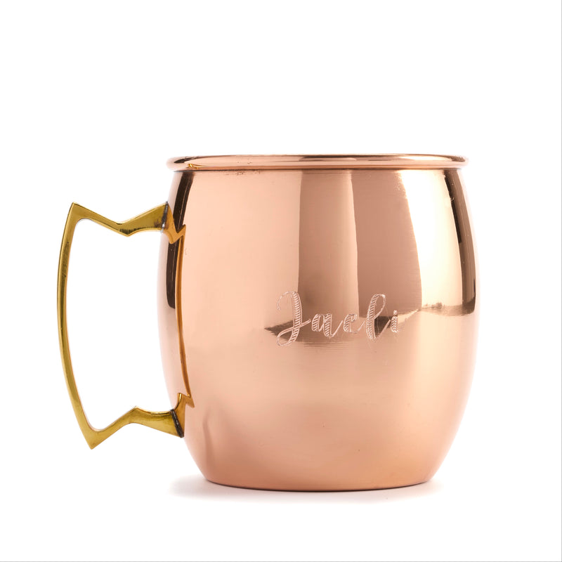 Copper mug with gold handle on a white background