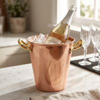 A copper champagne or wine bucket filled with ice, holding a bottle of Prosecco.