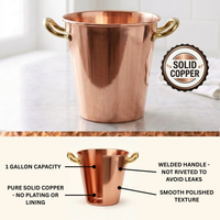 A polished copper ice bucket with two gold-toned handles, shown on a light marble surface with a 'Solid Copper' badge. The lower section includes a labeled diagram highlighting features such as 1 gallon capacity, pure solid copper, welded handles, and a smooth polished texture.