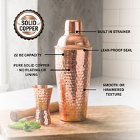 A hammered solid copper cocktail shaker and matching jigger on a wooden surface with callout  text pointing out features like built-in strainer, leak-proof seal, 22 oz capacity, pure solid copper, and hammered texture.