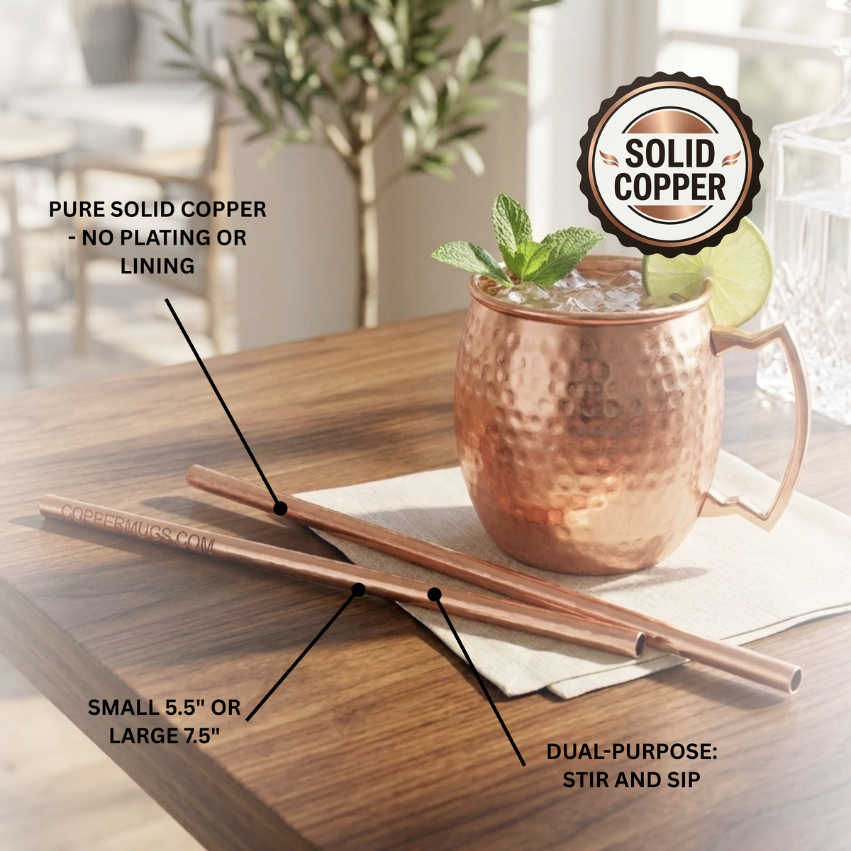 Two copper straws displayed on a wooden table next to a hammered copper mug with a cocktail, with text callouts describing the straws as pure solid copper, sizes small or large, and dual purposed for stirring and sipping.
