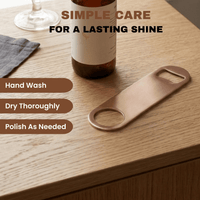 An image of a copper plated bottle opener with care instructions overlayed on the image.