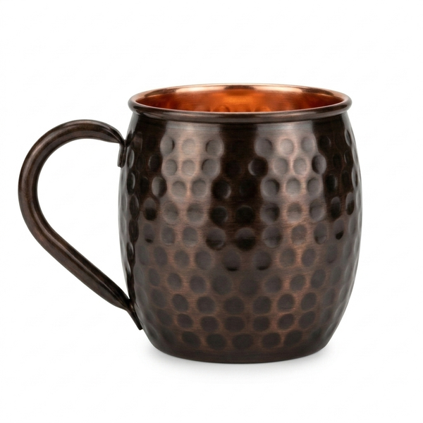 A hammered copper mug with a curved handle, dark lacquer and a polished copper interior, shown on a plain white background. 