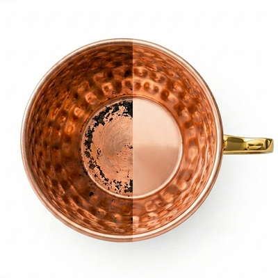 Copper mug with a textured interior on a white background half polished
